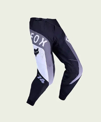 black moto pants on green background